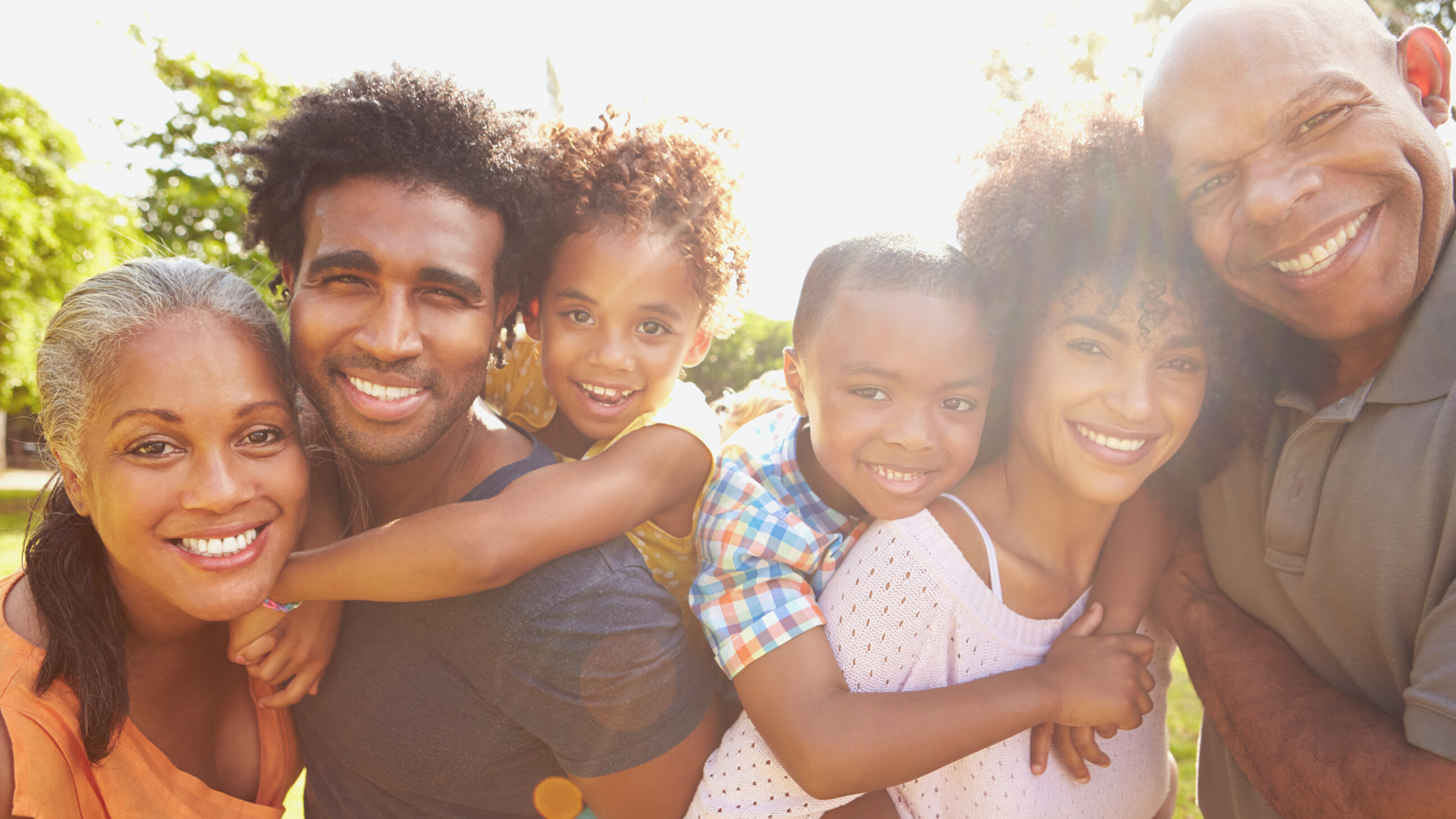 Family smiling together outdoors